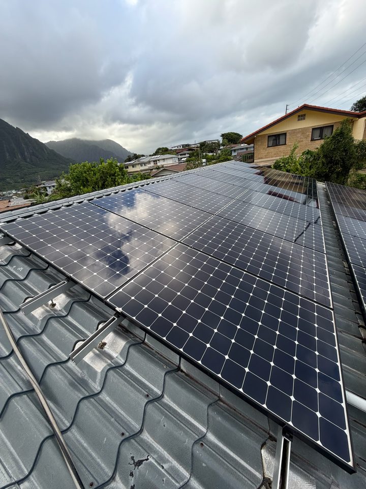 Clean solar array on a metal tile roof with the mountains behind
